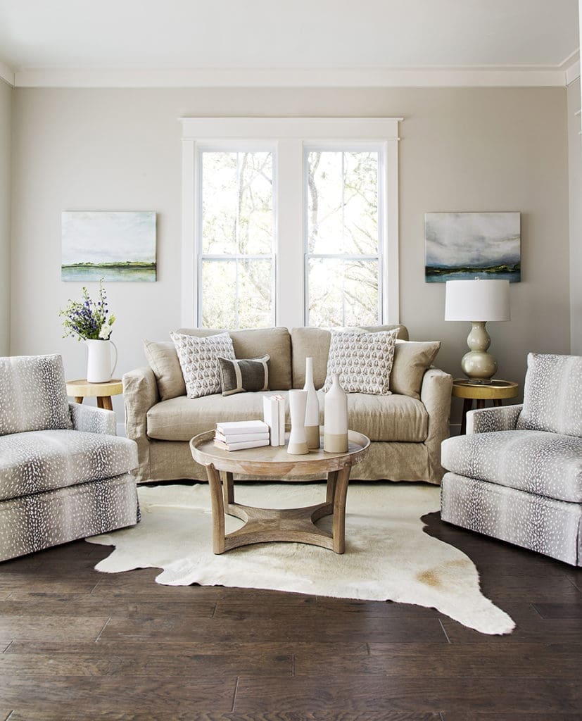 fawn pattern upholstered chairs and cowhide rug in living room design