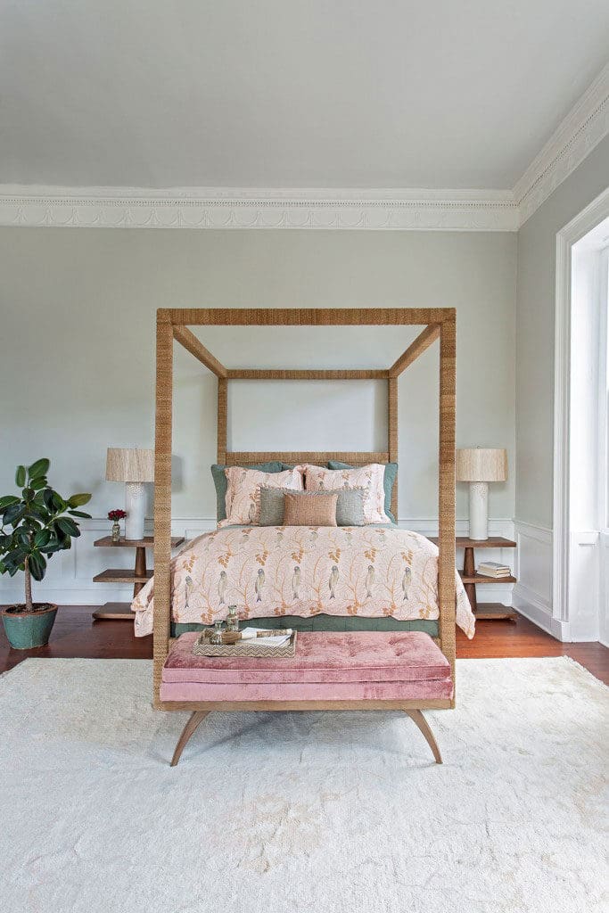 Neutral-toned rug beneath a wood poster bed