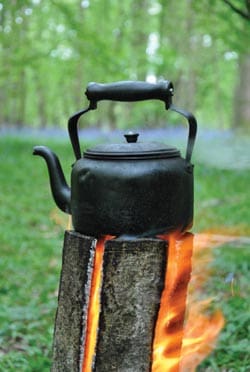 iron kettle on a log fire