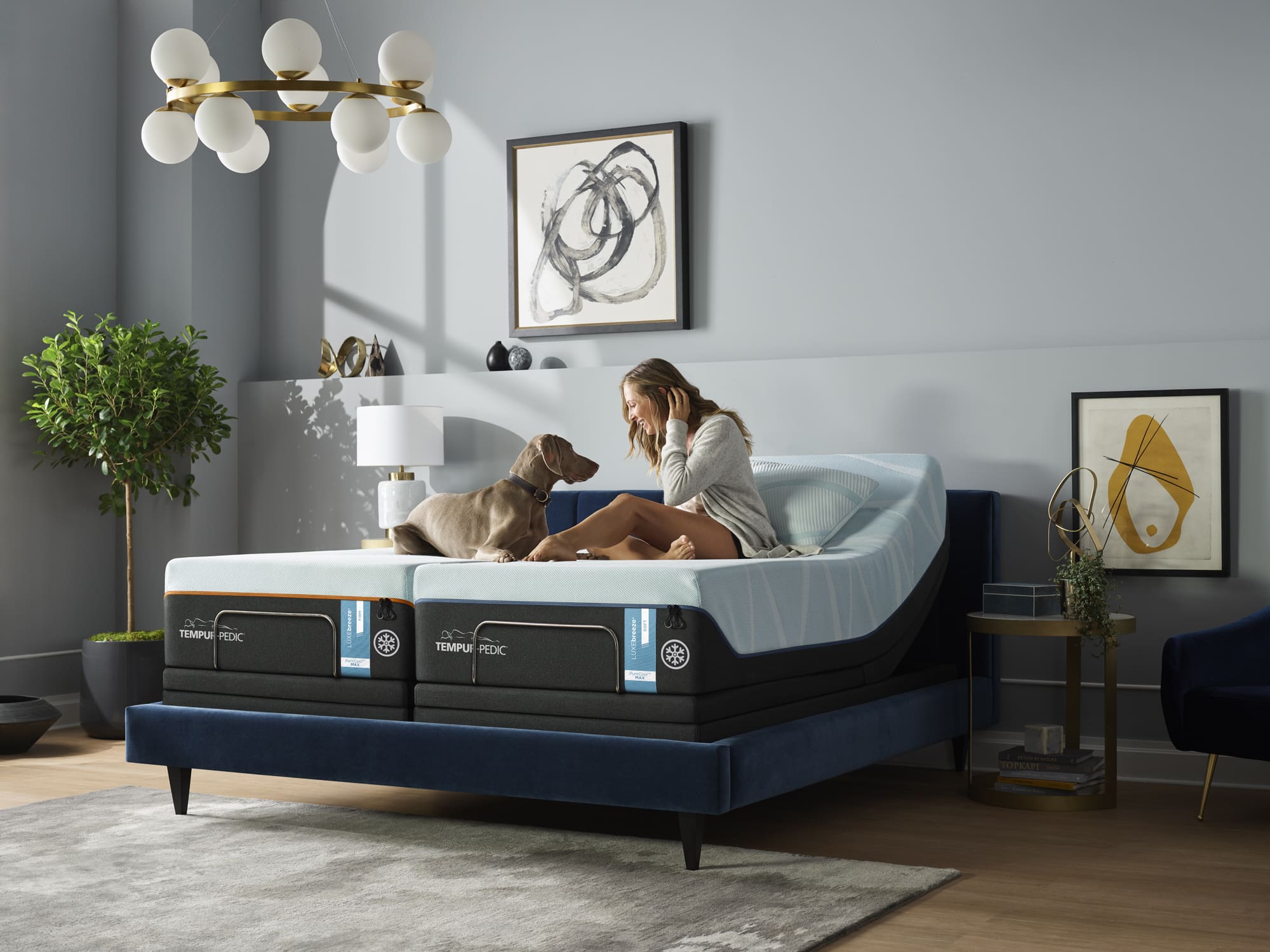 Woman on Tempur-Pedic mattress with dog in bedroom