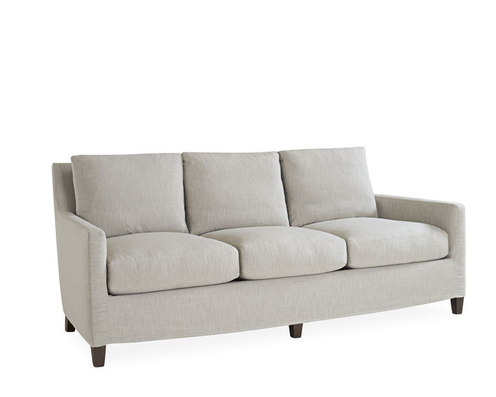 The Tanner Slipcovered Sofa has a classic shape, with simple legs and smooth, minimalistic upholstery. Find it at Mt. Pleasant furniture stores