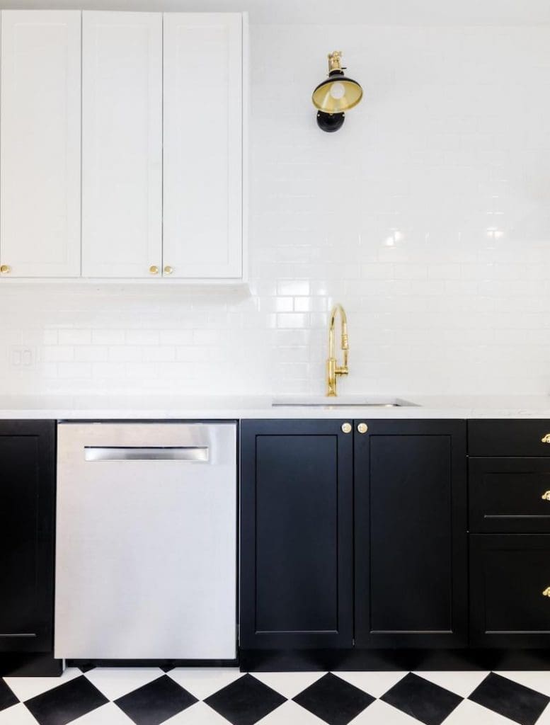 Black cabinets paired with black and white tiled floor and lighting fixtures with black accents by Charleston SC furniture store GDC