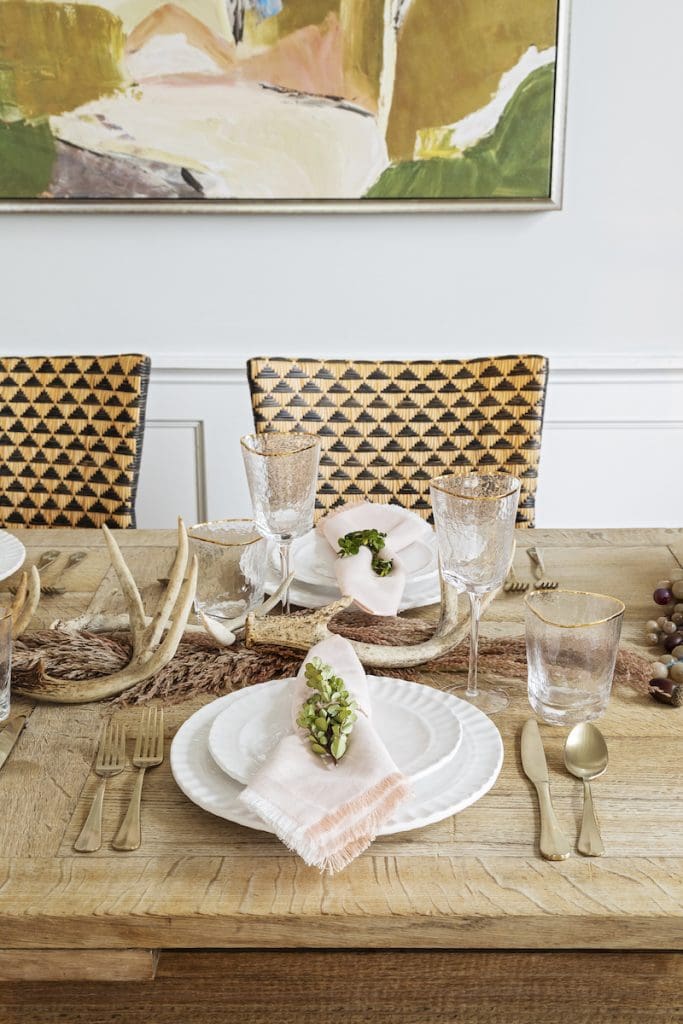 Holiday Tablescape Ideas by Mt Pleasant furniture store GDC — muted hues and natural textures like antlers, wood, and rosemary as holiday table decor